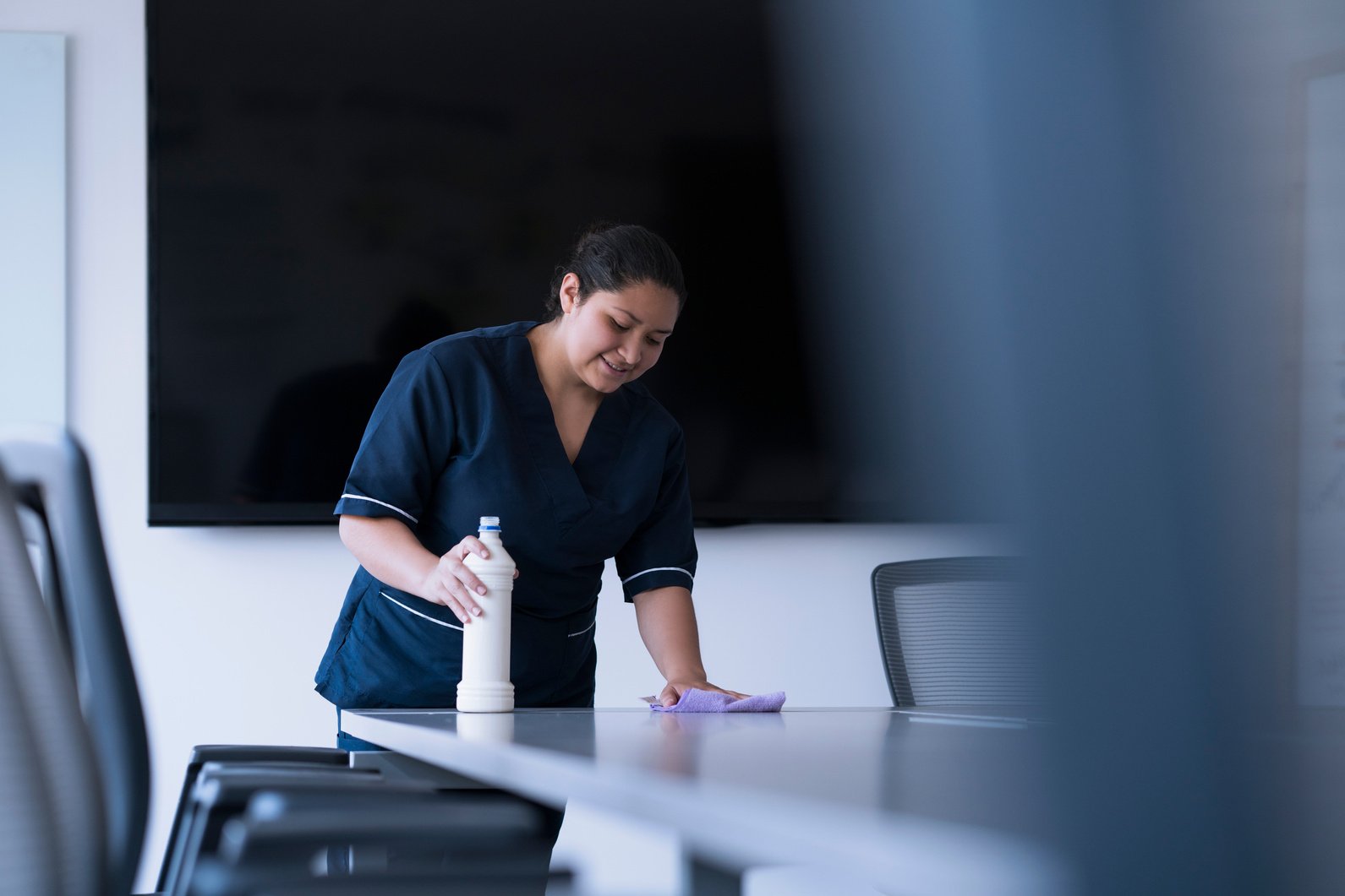 woman cleaning desk